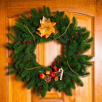 Christmas wreath with red sock on the door