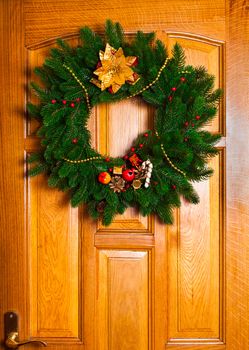 Christmas wreath with red sock on the door