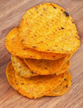 Stack of Homemade Potato Chips closeup on Wooden background