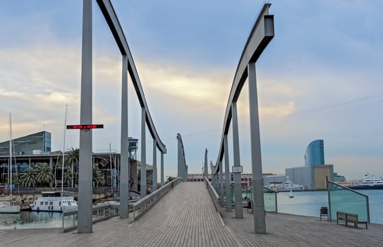 The Rambla de Mar was designed by Viaplana and Pinon, who created a wooden suspension bridge with a wavy pattern, symbolizing the connection of the city with the Mediterranean.