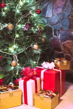 Presents boxes under the Christmas tree. Gold, red and white colours