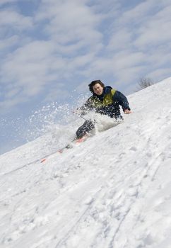 Skier falling on a steep snow slope
