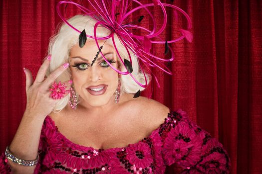 Smiling big beautiful woman fixing hair over curtain background