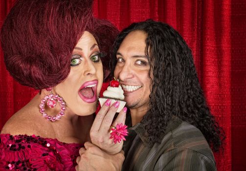 Drag queen with close friend eating cupcakes