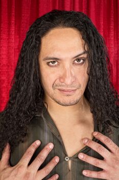 Close up of sensual Hispanic man with long hair