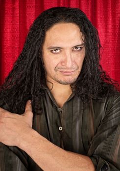 Attractive Latino man with long hair and eyeliner