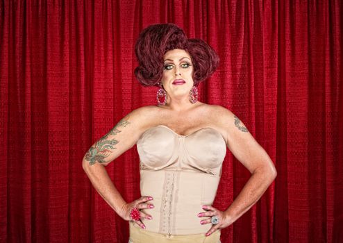 Drag queen in corset with hands on hips