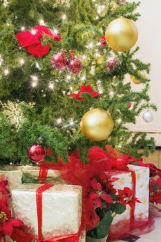 Christmas Tree Decorated with Ornaments Poinsettia Sparkling Lights Snowflakes with Wrapped Gifts Under the Tree