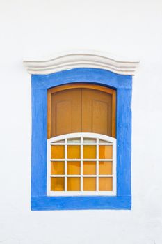 Decorative, colonial, blue, vintage, window on a white wall in Paraty (or Parati), Brazil.