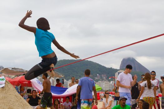 RIO DE JANEIRO - NOVEMBER 03 2012: Slackline contestant on the sands of Copacabana in Rio Elephant Cup tournament, held on November  03, 2012 on Copacabana, Rio de Janeiro, Brazil.