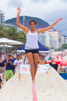 RIO DE JANEIRO - NOVEMBER 03 2012: Slackline contestant on the sands of Copacabana in Rio Elephant Cup tournament, held on November  03, 2012 on Copacabana, Rio de Janeiro, Brazil.