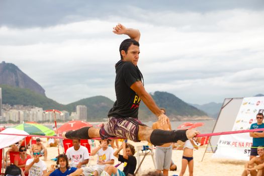 RIO DE JANEIRO - NOVEMBER 03 2012: Slackline contestant on the sands of Copacabana in Rio Elephant Cup tournament, held on November  03, 2012 on Copacabana, Rio de Janeiro, Brazil.