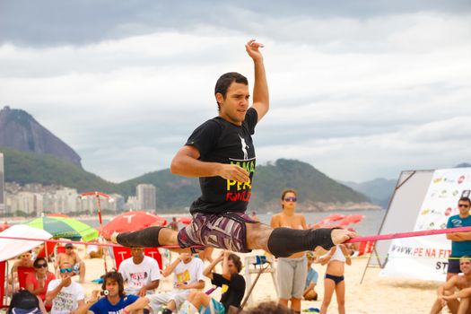 RIO DE JANEIRO - NOVEMBER 03 2012: Slackline contestant on the sands of Copacabana in Rio Elephant Cup tournament, held on November  03, 2012 on Copacabana, Rio de Janeiro, Brazil.