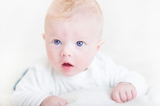 Cute blonde little baby boy with blue eyes.