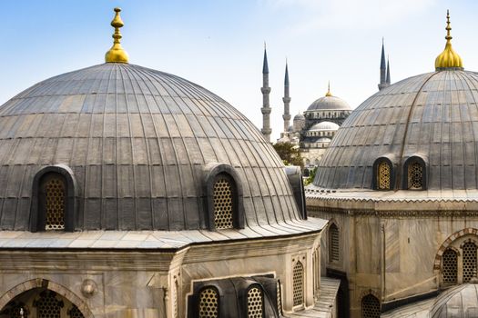 Blue Mosque or Sultan Ahmed Mosque viewed trough the window of Hagia Sophia, former Orthodox patriarchal basilica (church), later a mosque, and now a museum in Istanbul, Turkey.