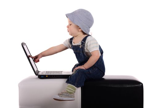 Little boy sitting with a laptop isolated on the white