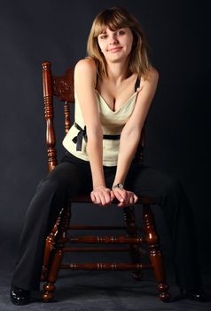 Young beautiful women sitting on a chair