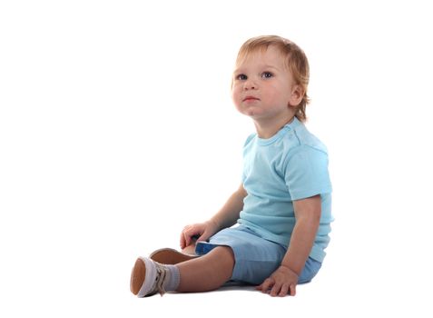 Little boy sitting isolated on the white