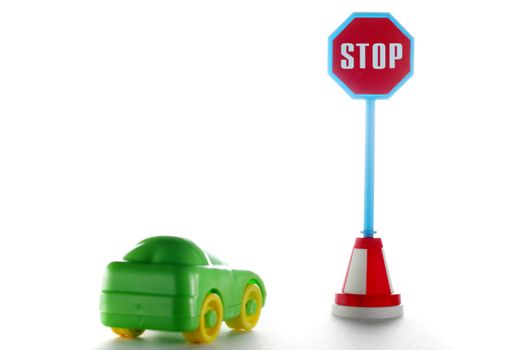 Car behind stop road sign on a white background