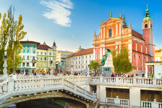 Romantic Ljubljana's city center:  river Ljubljanica, Triple Bridge (Tromostovje), Preseren square and Franciscan Church of the Annunciation; Ljubljana, Slovenia, Europe.