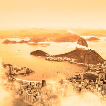 Rio de Janeiro, Brazil. Suggar Loaf and  Botafogo beach viewed from Corcovado at sunrise.