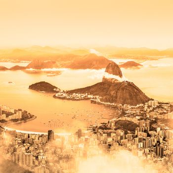 Rio de Janeiro, Brazil. Suggar Loaf and  Botafogo beach viewed from Corcovado at sunrise.