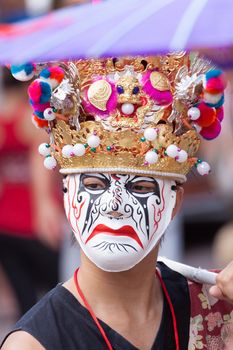 Actor wearing a traditional Japanese mask.