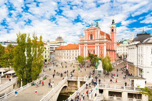 Romantic Ljubljana's city center:  river Ljubljanica, Triple Bridge (Tromostovje), Preseren square and Franciscan Church of the Annunciation; Ljubljana, Slovenia, Europe.