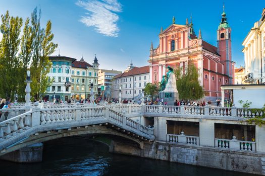 Romantic Ljubljana's city center:  river Ljubljanica, Triple Bridge (Tromostovje), Preseren square and Franciscan Church of the Annunciation; Ljubljana, Slovenia, Europe.