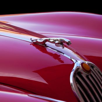 Detail of the metallic red luxury retro sports car.