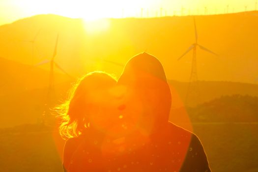 Lady hugging her boyfriend on their day trip in the nature.