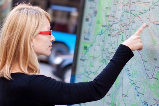 Woman orientating herself on the public transport map.