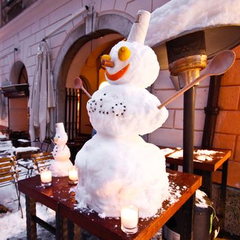 Snowman infront of the bar in Ljubljana's city sentre inviting people in.