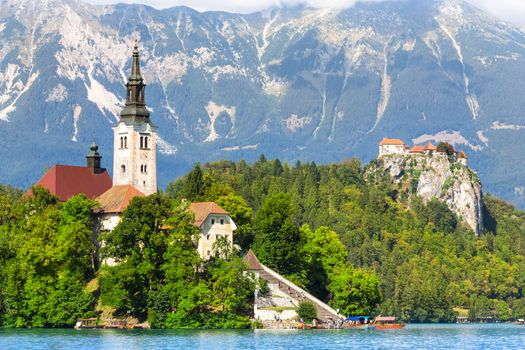 Panoramic view of  Julian Alps, Bled's castle on a cliff above the lake Bled with St. Marys Church of the Assumption on the small island; Bled, Slovenia, Europe.