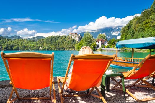 Traveler enjoying the panoramic view of Bled's castle on a cliff above the lake Bled, Slovenia, Europe.