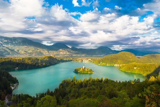 Panoramic view of  Julian Alps, Lake Bled with St. Marys Church of the Assumption on the small island; Bled, Slovenia, Europe.