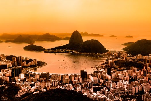 Rio de Janeiro, Brazil. Suggar Loaf and  Botafogo beach viewed from Corcovado at sunset. Rio de Janeiro is the 2016 summer olympic games hosting city.