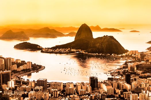 Rio de Janeiro, Brazil. Suggar Loaf and  Botafogo beach viewed from Corcovado at sunset.