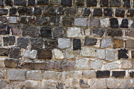 Old styled wall made from different stone blocks