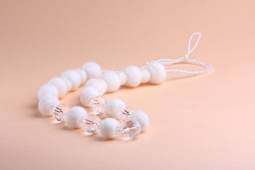 White beautiful beads at pink background
