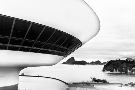 The Niteroi Contemporary Art Museum ( Museu de Arte Contemporanea de Niteroi - MAC ) is situated in the city of Niteroi, Rio de Janeiro, Brazil, and is one of the city���s main landmarks. Black and white.
