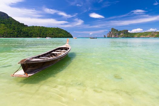 Traditional wooden  boats on a picture perfect tropical beach on Koh Phi Phi Island, Thailand, Asia.