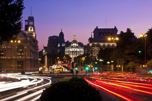 Rays of traffic lights on Calle de Alcala street and Cibeles square in Madrid at night. Spain.