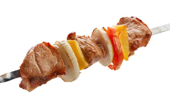 Hot roasted meat with onion, tomato and papper on the metal skewer