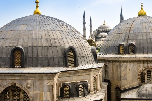 Blue Mosque or Sultan Ahmed Mosque viewed trough the window of Hagia Sophia, former Orthodox patriarchal basilica (church), later a mosque, and now a museum in Istanbul, Turkey.