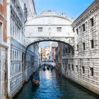 Gondolas passing under the Bridge of Sighs - Ponte dei Sospiri. A legend says that lovers will be granted eternal love if they kiss on a gondola at sunset under the Bridge. Venice,Veneto, Italy, Europe.