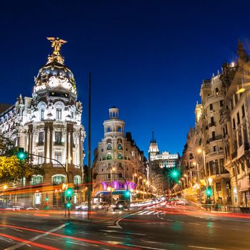 Rays of traffic lights on Gran via street, main shopping street in Madrid at night. Spain, Europe.