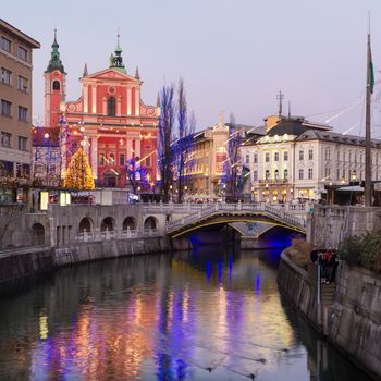 Romantic Ljubljana's city center  decorated for Christmas time. River Ljubljanica, Triple Bridge (Tromostovje) and  Preseren's square; Ljubljana, Slovenia, Europe.