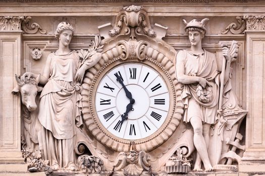 Antic ornate clock on one of the medieval hose facades in Montpellier, south France, Europe