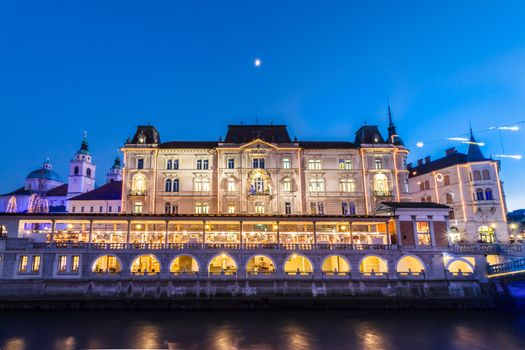 Ljubljana, Slovenia, Europe - Ljubljanica River and Central Market in dusk. Ljubljana open market buildings was designed by famous architect Jo��e Plecnik.